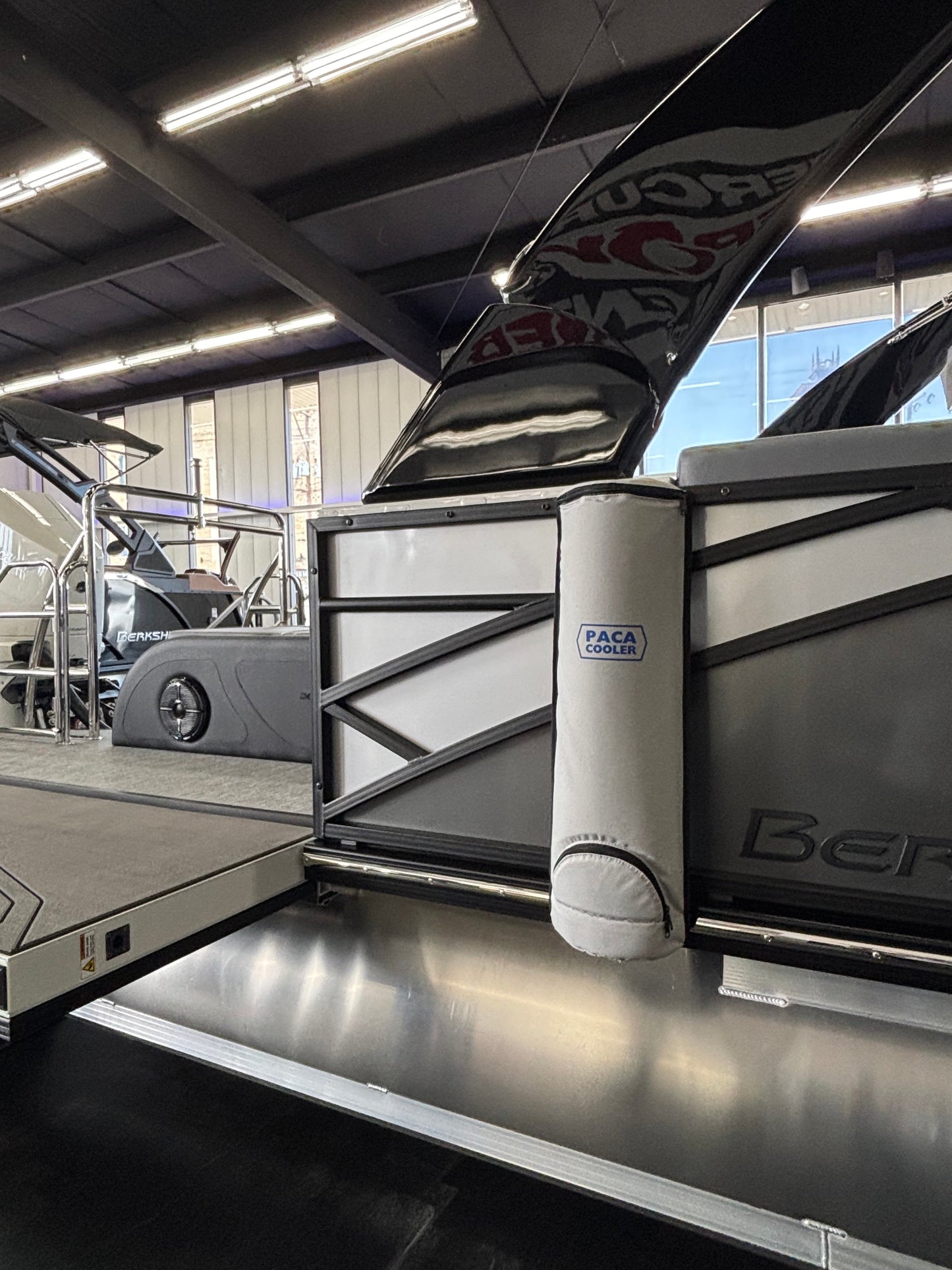 Pontoon boat with a Paca Cooler attached to it.