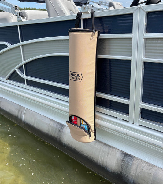 Blue pontoon boat with a Tan Paca Cooler hanging on the side of the pontoon boat. 